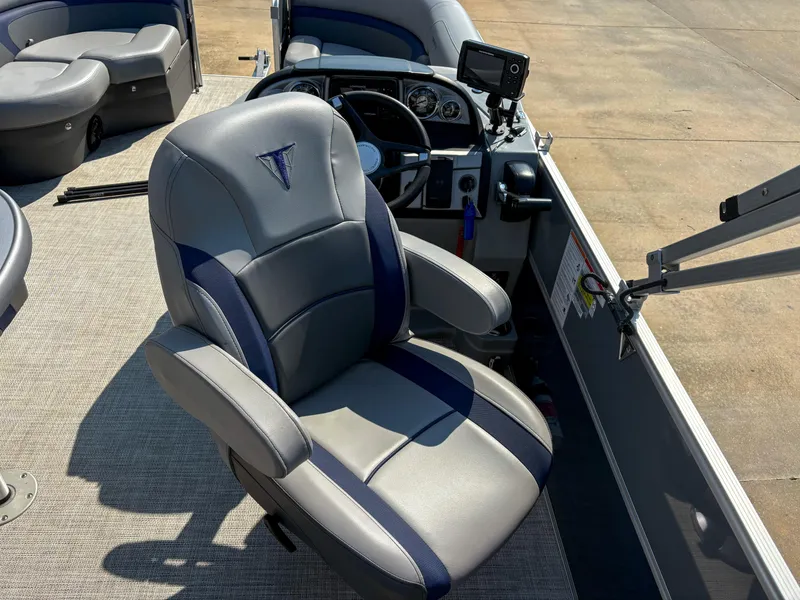 Slide: The Image of Captain's chair and dashboard of 2022 Trifecta CS 24RFC boat, featuring modern controls. - 6