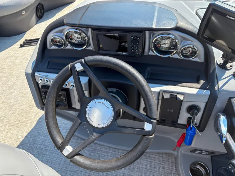 Slide: The Image of Steering console of 2022 Trifecta CS 24RFC boat with gauges and controls. - 7
