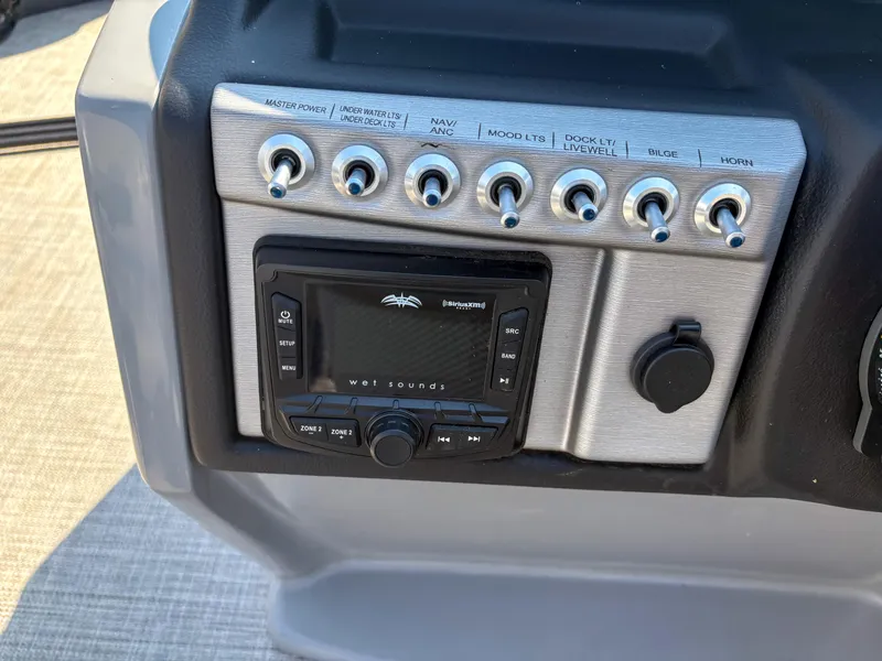 Slide: The Image of Control panel of 2022 Trifecta CS 24RFC boat with switches and audio system. - 9