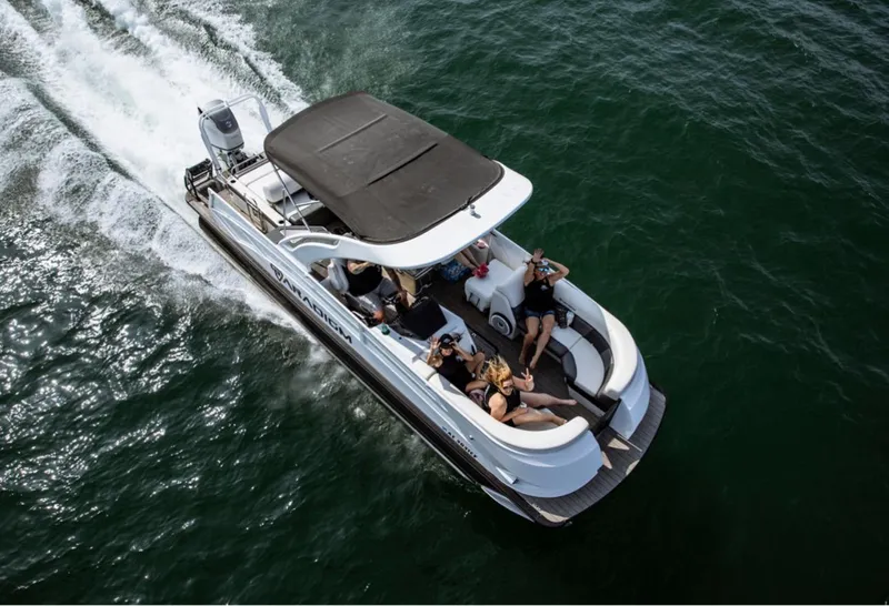 Slide: The Image of 2024 Paradigm 27SS boat cruising on open water with passengers relaxing. - 1