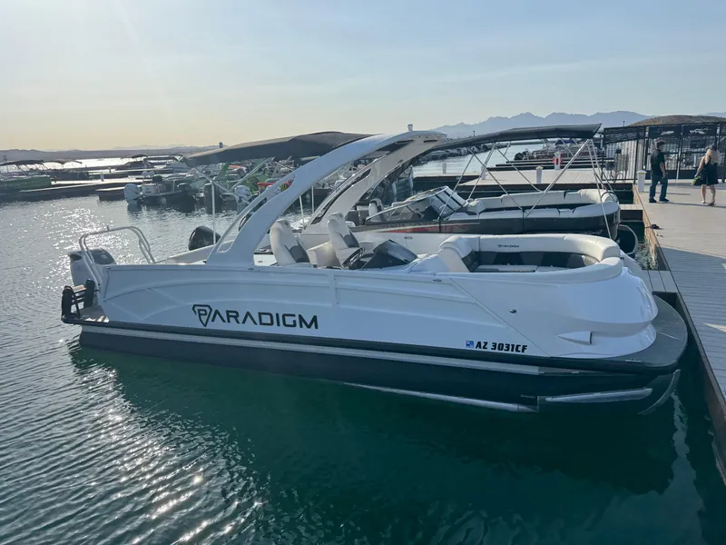 Slide: The Image of 2024 Paradigm 27SS boat docked at marina, with sleek design and modern features. - 2