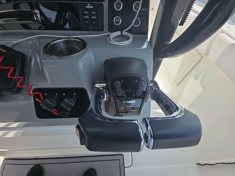Slide: The Image of 2021 Robalo R272 Center Console boat controls with Yamaha throttle and steering wheel. - 10