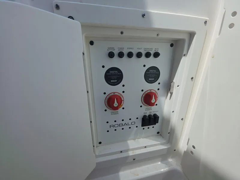 Slide: The Image of Control panel of 2021 Robalo R272 Center Console boat with switches and dials. - 12