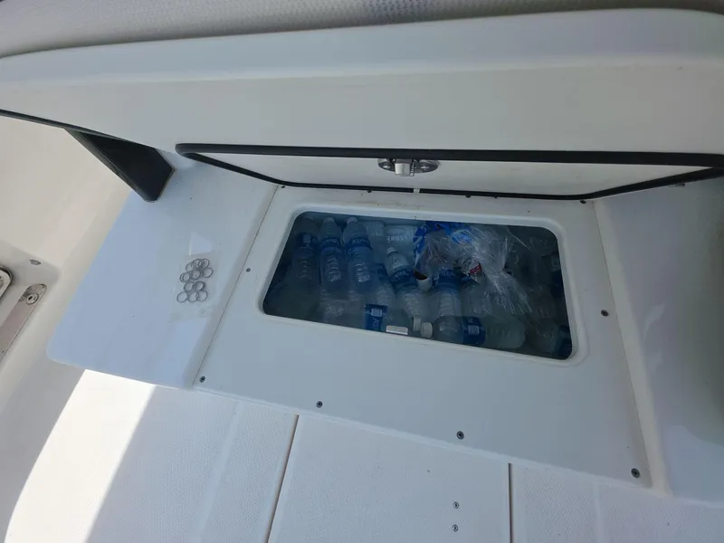 Slide: The Image of 2021 Robalo R272 Center Console cooler with bottled water storage. - 17