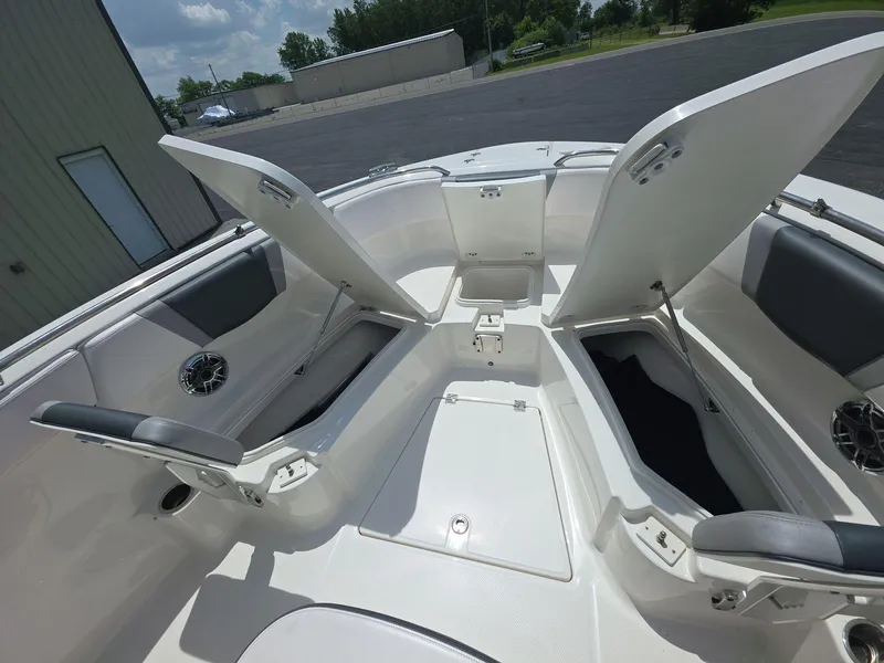 Slide: The Image of 2021 Robalo R272 Center Console boat with open storage compartments and seating. - 6