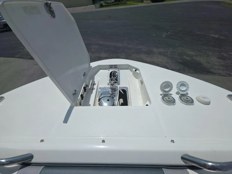 Slide: The Image of 2021 Robalo R272 Center Console boat with open anchor hatch and deck fittings. - 7