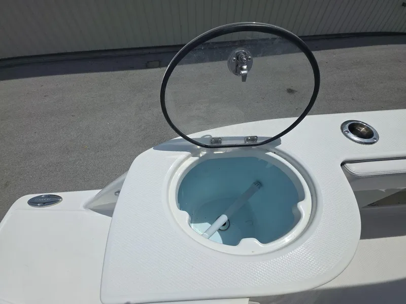 Slide: The Image of 2021 Robalo R272 Center Console livewell with open lid on deck. - 8