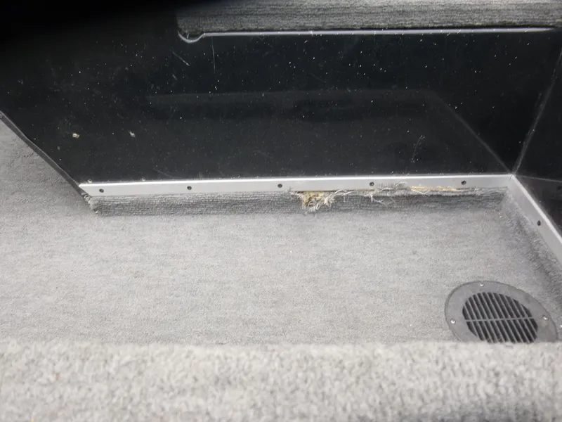 Slide: The Image of Interior of 1999 Viper Boats Cobra 180 showing carpeted flooring and vent detail. - 13