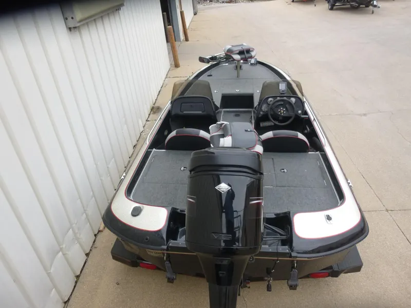Slide: The Image of 1999 Viper Boats Cobra 180, black and white, parked outdoors, rear view of interior and motor. - 2