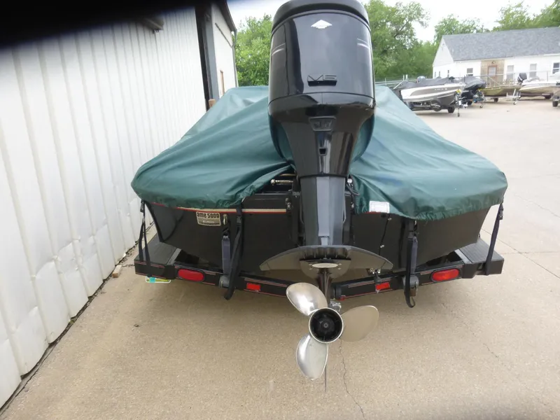 Slide: The Image of 1999 Viper Boats Cobra 180 with green cover and outboard motor on trailer. - 4