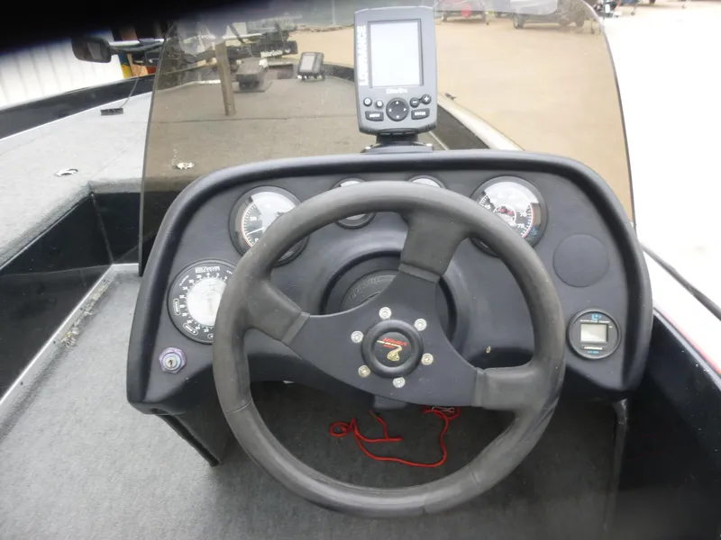Slide: The Image of 1999 Viper Boats Cobra 180 dashboard with steering wheel and gauges. - 6