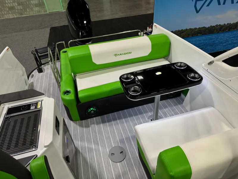 Slide: The Image of 2025 Paradigm 25SS boat interior with green seating and a black table. - 3
