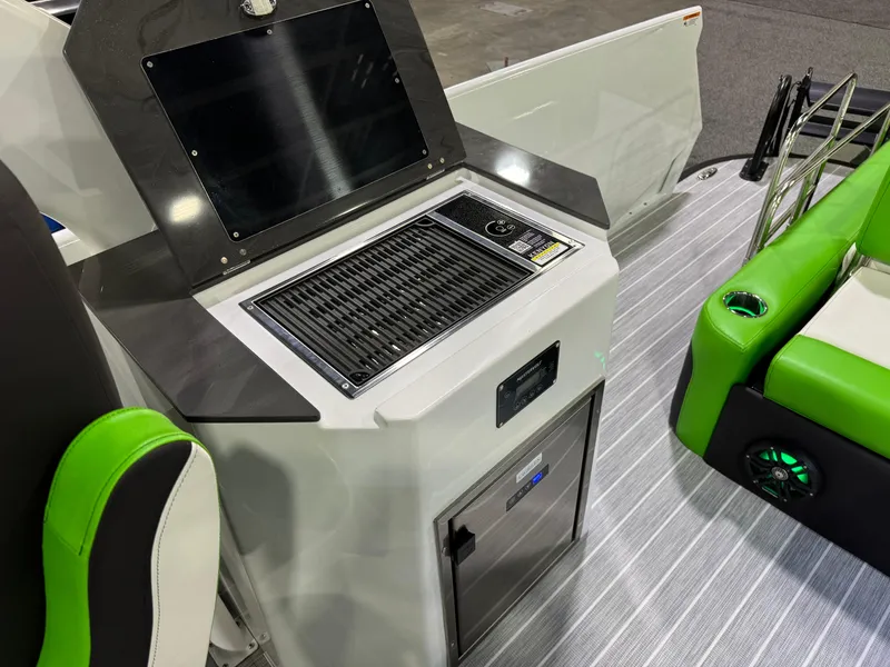 Slide: The Image of 2025 Paradigm 25SS boat interior with grill, green seating, and modern design. - 4