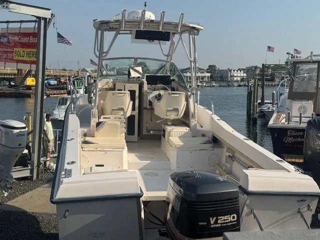 Slide: The Image of 1994 Grady-White Explorer 244 boat docked at marina with outboard motor. - 12