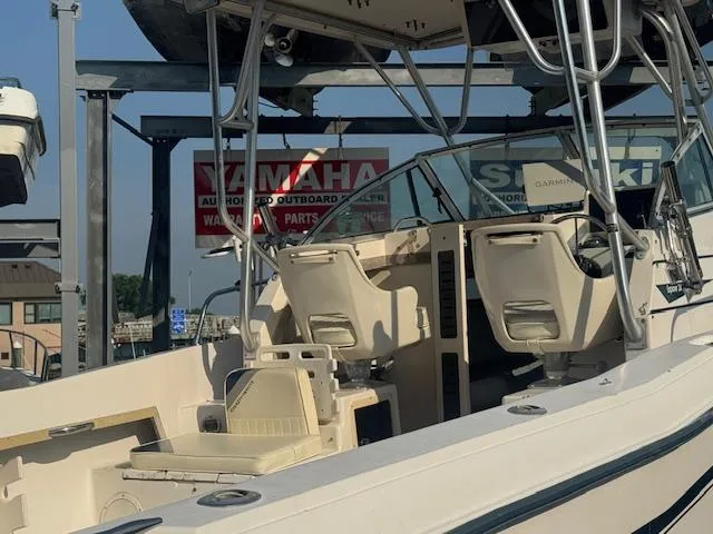 Slide: The Image of 1994 Grady-White Explorer 244 boat with Yamaha and Suzuki signage in the background. - 2