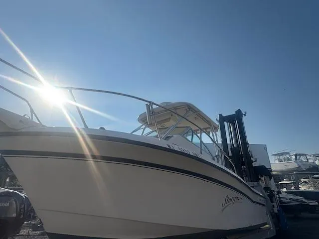 Slide: The Image of 1994 Grady-White Explorer 244 boat under bright sun, docked at marina. - 9