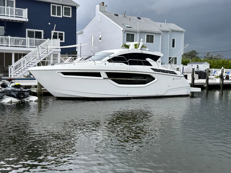 The Image of 2018 Cruisers Yachts 42 Cantius docked near waterfront homes. - 1