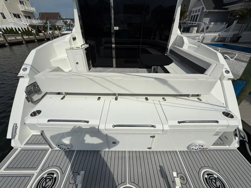 Slide: The Image of 2018 Cruisers Yachts 42 Cantius, rear deck view with seating and storage. - 10