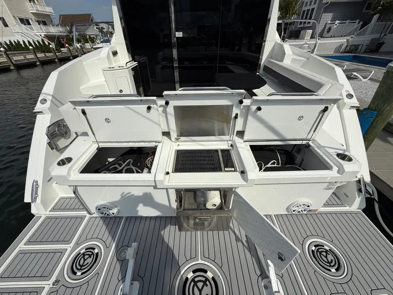 Slide: The Image of 2018 Cruisers Yachts 42 Cantius deck with open storage compartments and grill. - 11