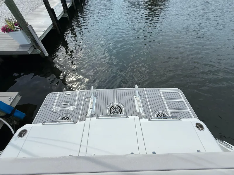 Slide: The Image of 2018 Cruisers Yachts 42 Cantius swim platform by the water. - 12
