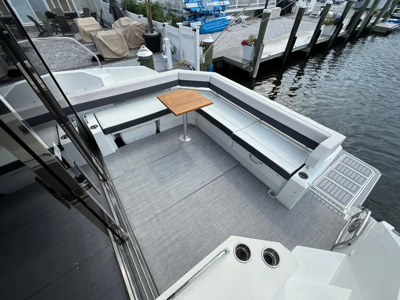 Slide: The Image of 2018 Cruisers Yachts 42 Cantius cockpit with seating and table, dockside view. - 14