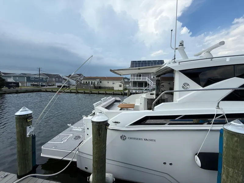 Slide: The Image of 2018 Cruisers Yachts 42 Cantius docked at marina, overcast sky. - 18