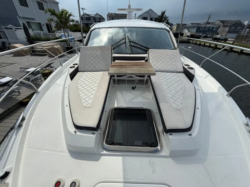 Slide: The Image of 2018 Cruisers Yachts 42 Cantius with sunbathing area and table on deck. - 22