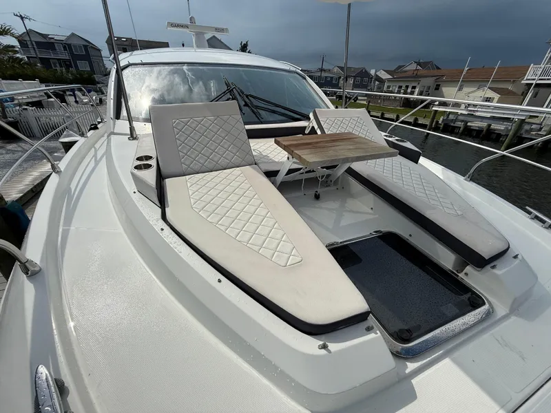 Slide: The Image of 2018 Cruisers Yachts 42 Cantius with sun loungers and table on deck. - 23