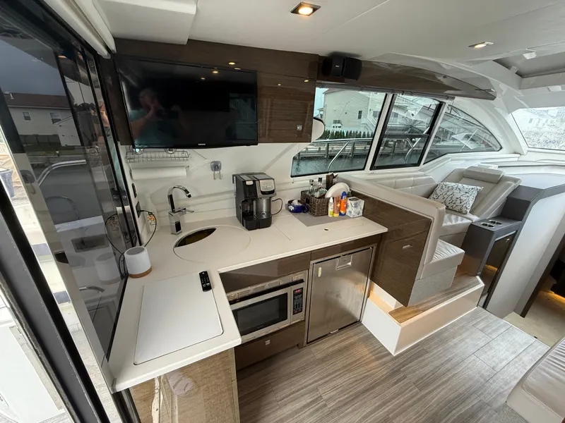 Slide: The Image of Luxurious interior of 2018 Cruisers Yachts 42 Cantius with modern kitchen and seating area. - 26
