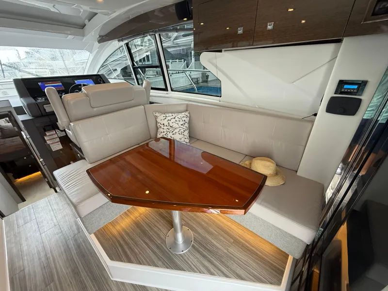 Slide: The Image of Luxurious interior of 2018 Cruisers Yachts 42 Cantius with elegant seating and wooden table. - 27