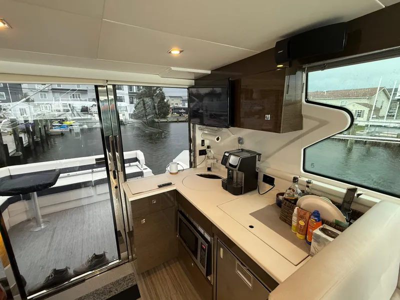 Slide: The Image of Interior of 2018 Cruisers Yachts 42 Cantius with modern kitchen and marina view. - 31