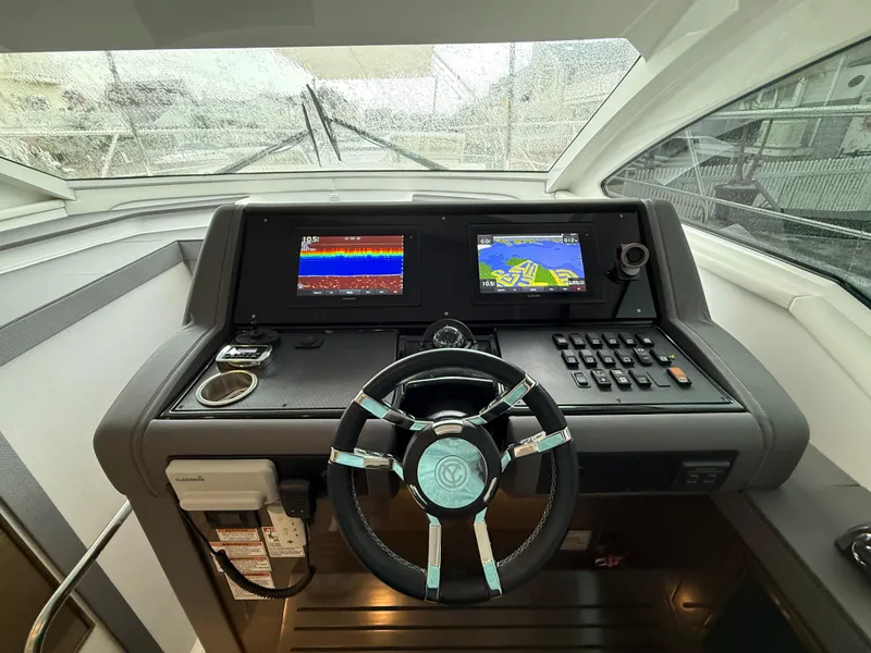 Slide: The Image of 2018 Cruisers Yachts 42 Cantius helm with navigation screens and steering wheel. - 41