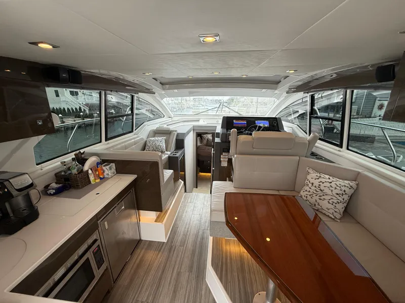 Slide: The Image of Interior of 2018 Cruisers Yachts 42 Cantius, featuring modern seating and kitchen area. - 28