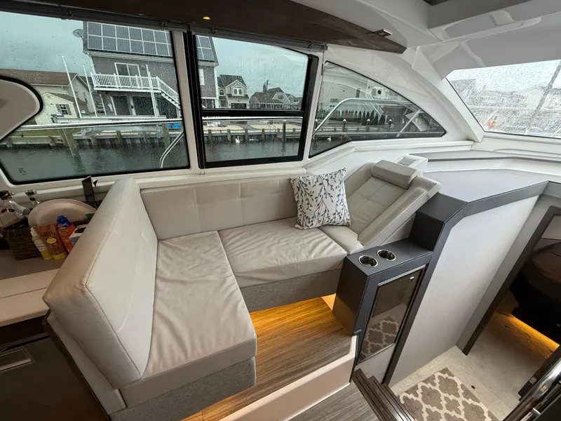 Slide: The Image of Luxurious interior of 2018 Cruisers Yachts 42 Cantius with plush seating and waterfront view. - 29