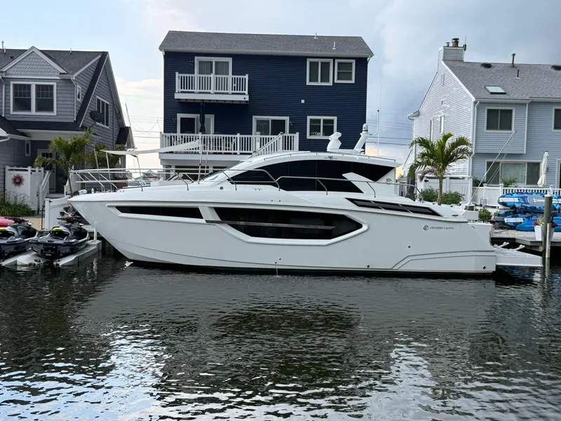 Slide: The Image of 2018 Cruisers Yachts 42 Cantius docked near waterfront homes. - 3