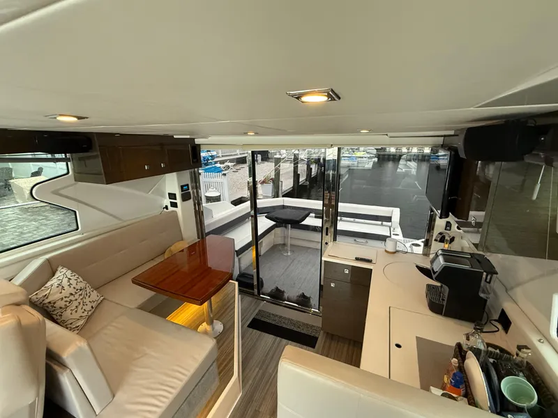 Slide: The Image of Interior of 2018 Cruisers Yachts 42 Cantius with modern seating and kitchenette. - 33