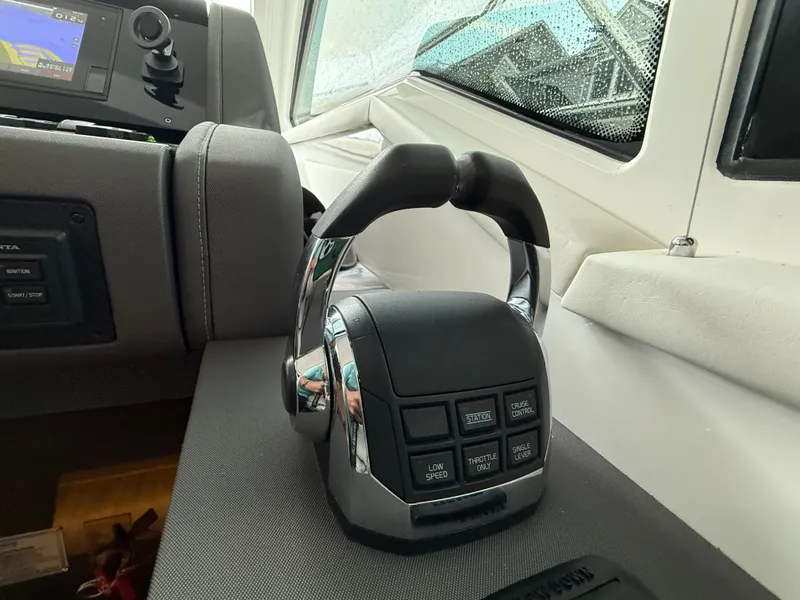 Slide: The Image of Control panel of 2018 Cruisers Yachts 42 Cantius with throttle and navigation display. - 37