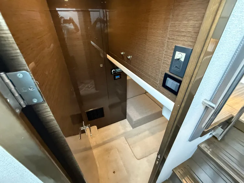 Slide: The Image of 2018 Cruisers Yachts 42 Cantius interior with modern wood paneling and control panel. - 44