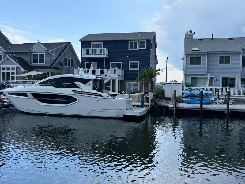 Slide: The Image of 2018 Cruisers Yachts 42 Cantius docked near waterfront homes. - 5