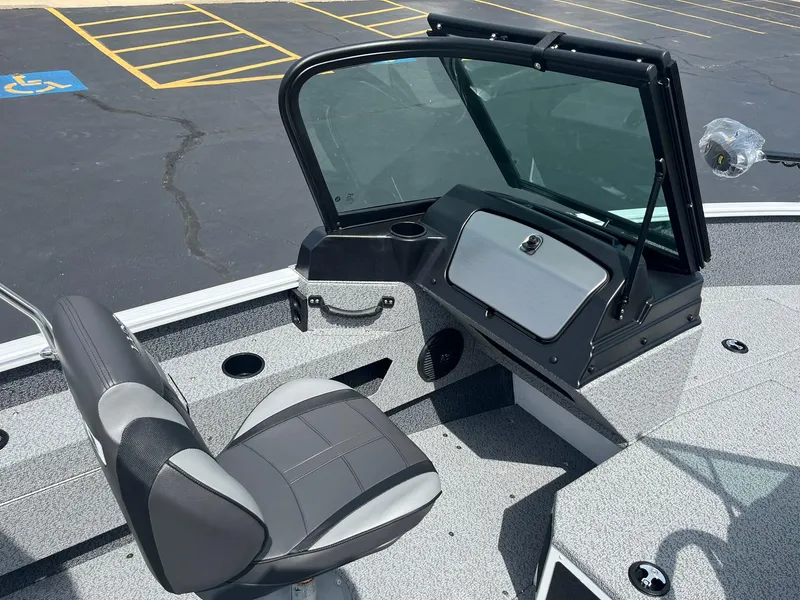 Slide: The Image of 2026 Lund 1675 Adventure Sport boat interior with seating and console. - 11