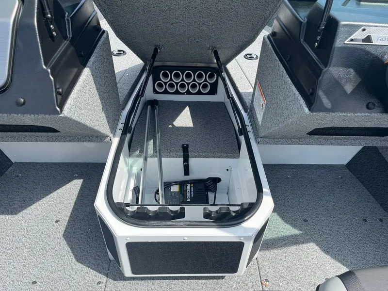Slide: The Image of 2026 Lund 1675 Adventure Sport boat interior storage compartment with rod holders. - 13