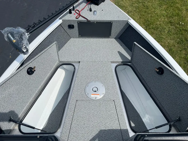 Slide: The Image of 2026 Lund 1675 Adventure Sport boat interior with open storage compartments. - 16