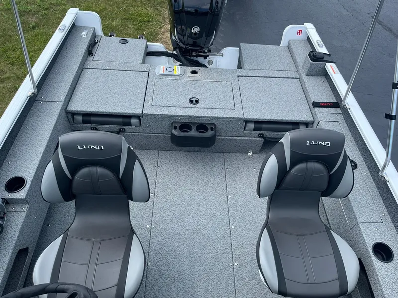 Slide: The Image of 2026 Lund 1675 Adventure Sport boat interior with two seats and storage compartments. - 18