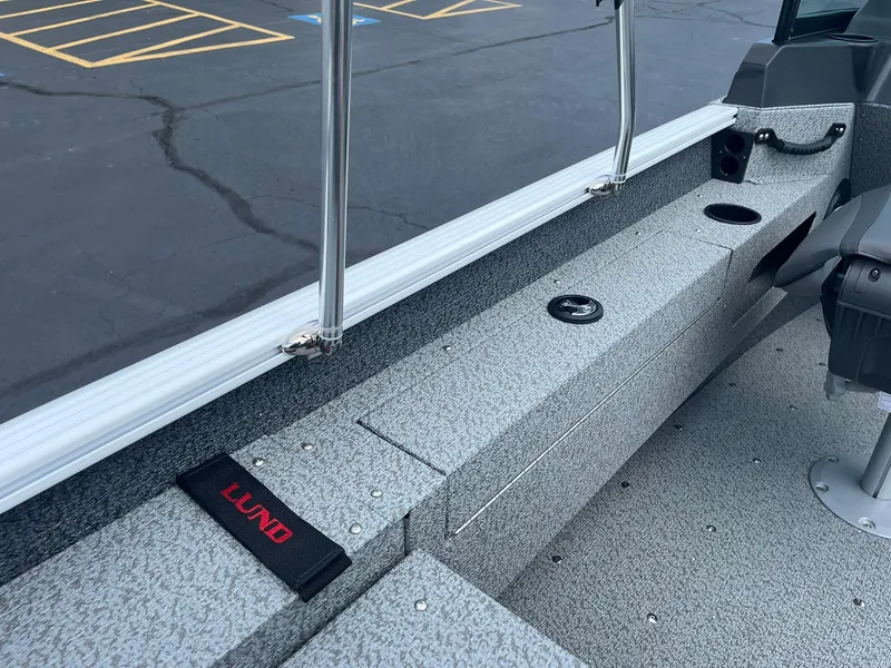 Slide: The Image of 2026 Lund 1675 Adventure Sport boat interior with gray textured flooring and seating. - 19