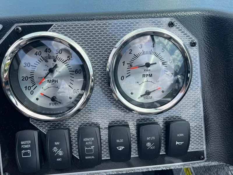 Slide: The Image of Dashboard of 2026 Lund 1675 Adventure Sport with speedometer, RPM gauge, and control switches. - 24