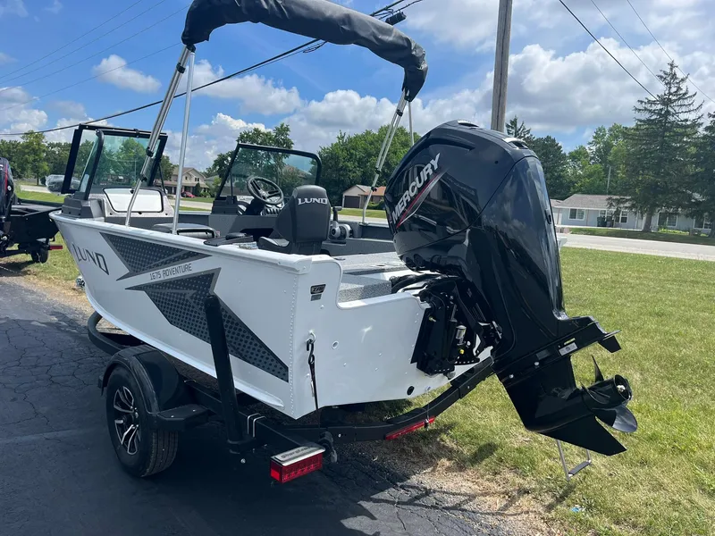 Slide: The Image of 2026 Lund 1675 Adventure Sport boat with Mercury outboard motor on a trailer. - 3