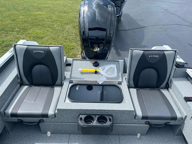 Slide: The Image of 2026 Lund 1675 Adventure Sport boat interior with two seats and storage compartments. - 8