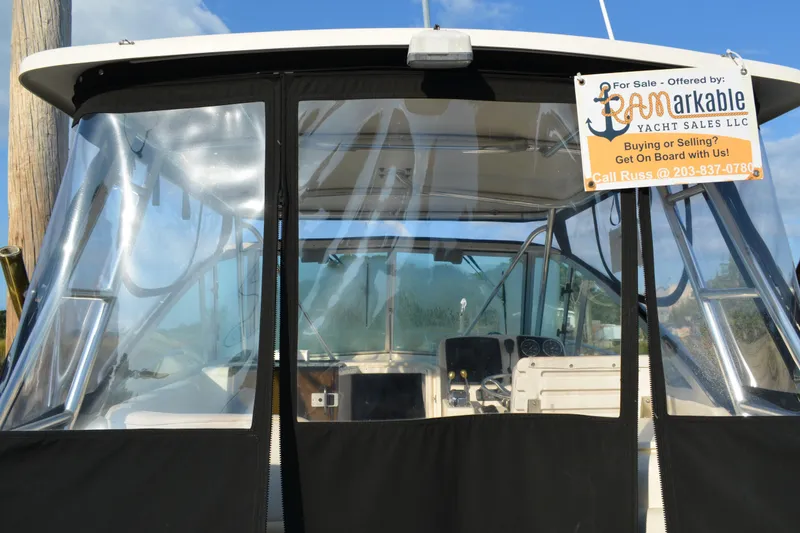 Slide: The Image of 2003 Pursuit 3000 Express boat for sale with contact information displayed. - 15