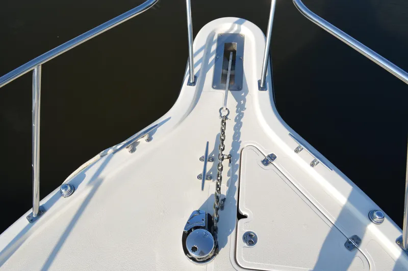 Slide: The Image of Bow of 2003 Pursuit 3000 Express boat with anchor chain and railing. - 11
