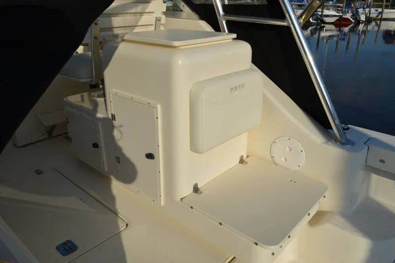 Slide: The Image of 2003 Pursuit 3000 Express boat interior with seating and storage compartments. - 21